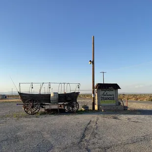 a horse drawn wagon parked in a parking lot