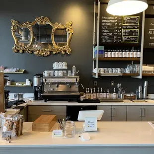 a coffee shop counter with a variety of items