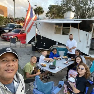 a group of people sitting at a picnic table