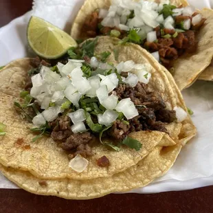 two tacos on a paper plate