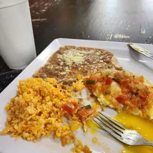Huevos Ranchero with rice and beans....sorry it's half of the dish..it comes with two fried eggs over tortillas..it was delicious!