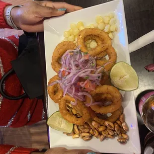 Calamari with boiled corn, fried corn, yuca (hidden under calamari) and salsa on top.