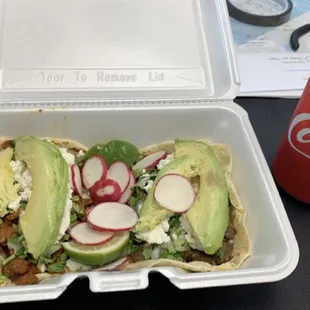 two tacos in a styrofoam container