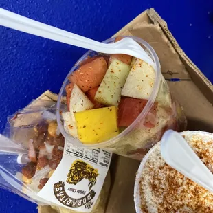 Cup of fruit papa's con chile, and corn on cup