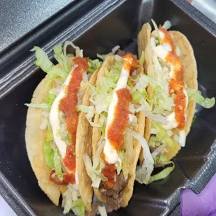 two tacos in a container