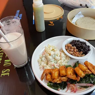 Fried shrimp plate with side of mac salad and beans, tortillas, horchata
