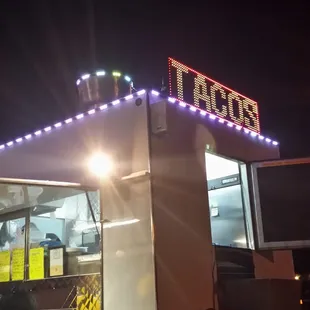  a taco stand lit up at night