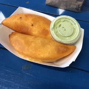 two pastries in a paper container