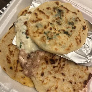 two flatbreads in a styrofoam container