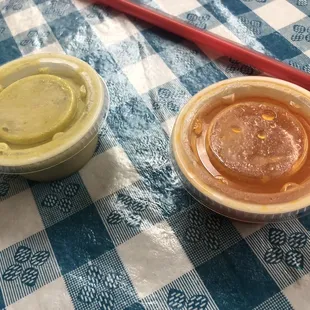 two bowls of sauce and a spoon
