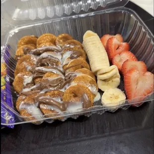 Pancakes drizzled with Nutella with strawberries and bananas