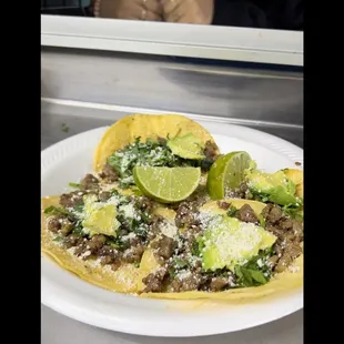 4mini Tacos with your choice of meat either Asada, Al Pastor or mix topped with Onions, Cilantro slices of Avocados and served with limes