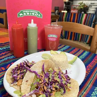Fish tacos with grill cheese chipotle mayonnaise sauce and avocado cream sauce with cabbage and lettuce and cilantro lime