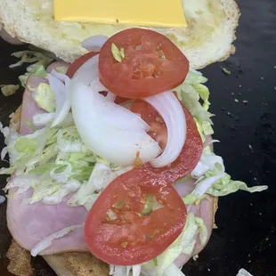 a sandwich with lettuce, tomato, and cheese