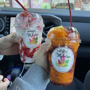 two people holding drinks in their hands