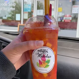 a person holding a drink in a car