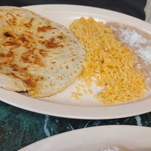 a plate of rice and a plate of quesadilla
