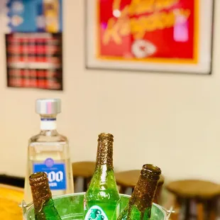 three bottles of beer in a bucket