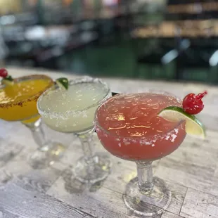 three cocktails on a table
