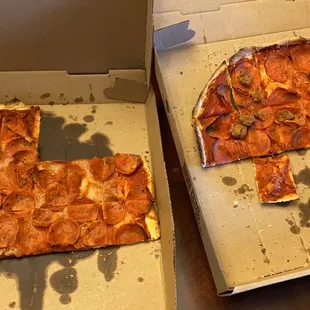 a half eaten pizza in a box