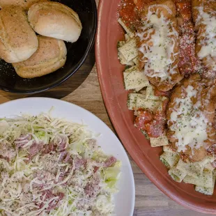 a plate of pasta and a bowl of bread