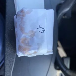 a bag of donuts in the driver&apos;s seat