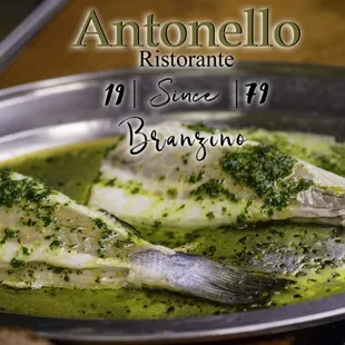 Branzino Herbs: Baked filet of European sea bass topped with fresh herbs and organic olive oil served with fresh lemon..
