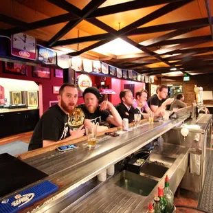 a group of people sitting at a bar