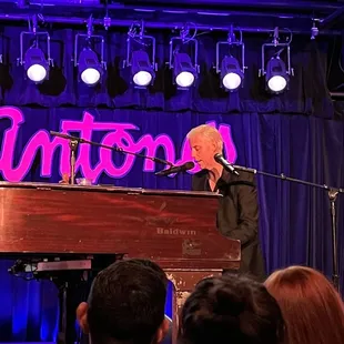 a man playing a grand piano