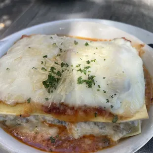 a plate of lasagna on a table