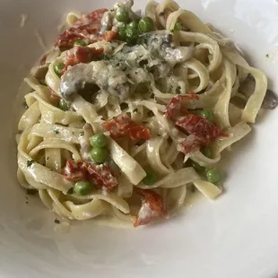 Fettuccine Alfredo with peas, sun dried tomatoes, and mushrooms