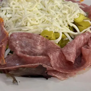 Antipasto salad, lettuce, mozzarella, peperoncini, salami