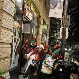 a group of people standing on the sidewalk