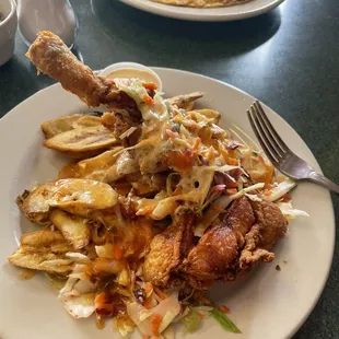 Chicken w/ fried green bananas and slaw. In the background. chorizo omelette and hash browns.