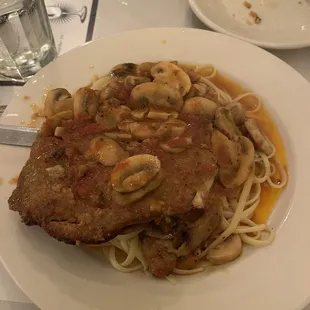 Veal cutlet stuffed with mozzarella over linguine and mushrooms