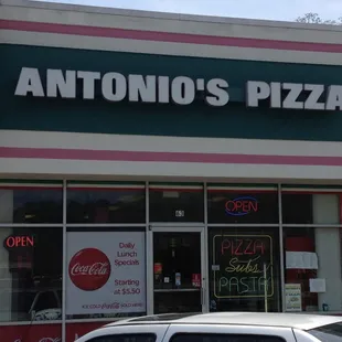 a car parked in front of a restaurant