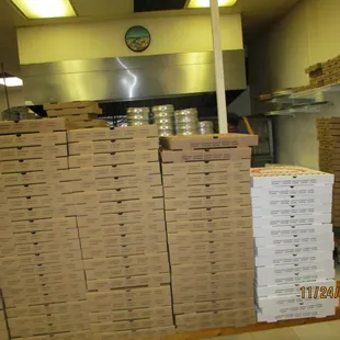 Stacks of pizza boxes. Whether by intent or no, a lot of the kitchen activity is hidden from the customer.