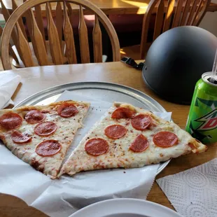 Two big pieces of pizza and a soda for $7. Good deal!
