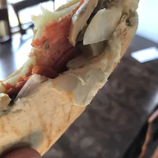 a hand holding a hot dog