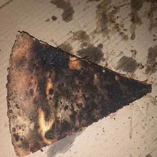 a burnt piece of pizza