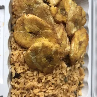 fried bananas and rice in a styrofoam container