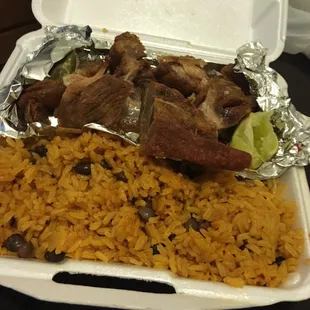 Fried Pork Spanish dinner with yellow rice and peas
