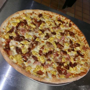 Breakfast Pizza made of Sausage, Egg, Bacon &amp; Onion