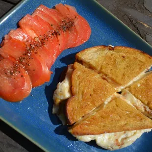 Sourdough grilled bread, olive oil, 40% ricotta, 60% mozzarella cheese, salt pepper, marinated tomatoes, (on top)