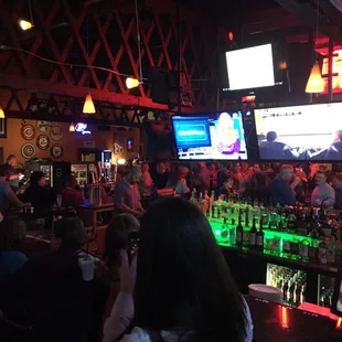 a large group of people sitting at the bar