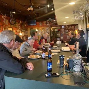 a group of people sitting at a bar