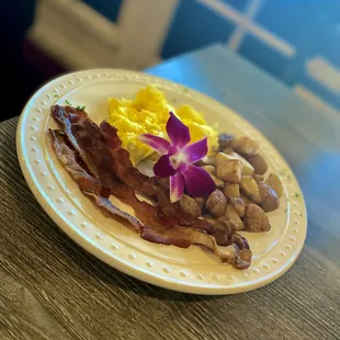 bacon, eggs, and potatoes on a plate