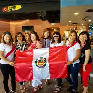 a group of women holding a mexican flag