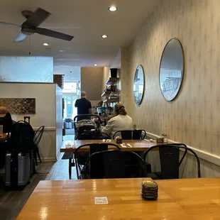 people sitting at tables in a restaurant