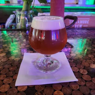 a glass of beer on a table